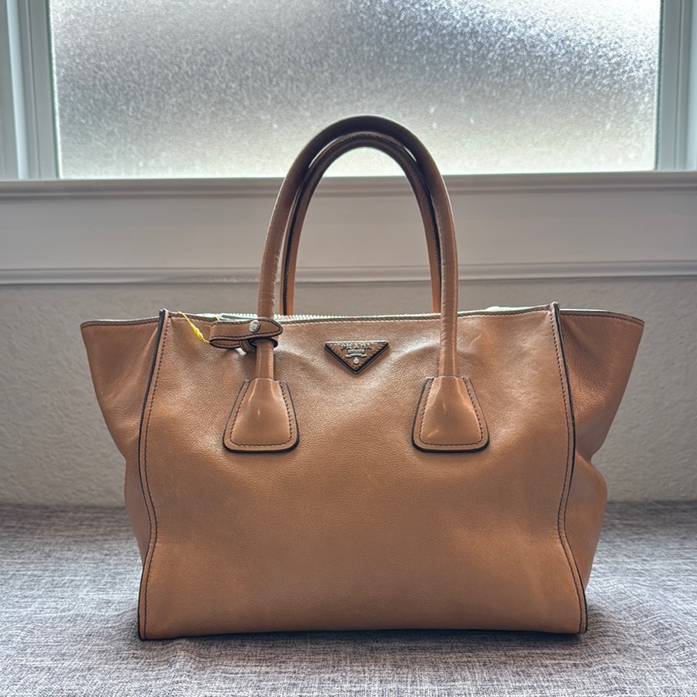 Prada Tan Leather Hand Purse with Elegant Winged Design
